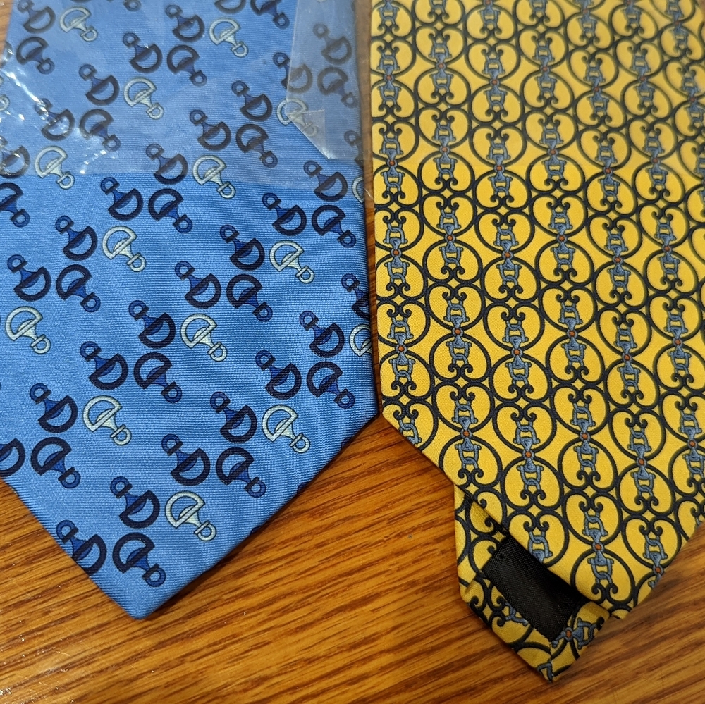 Two blue and yellow patterned silk ties.